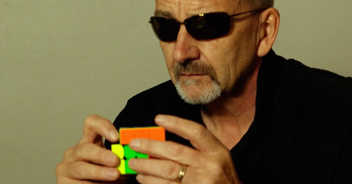 Doug Foulkes solving a 3x3 Rubik's Cube representing the six signals of GEO